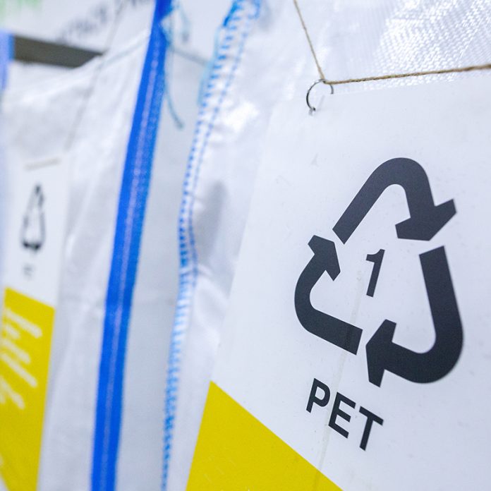 Sorting recyclables. The sorted polyethylene terephthalate (PET) plastic, is placed in a container with the appropriate marking.