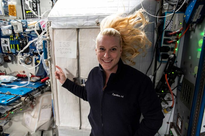 ISS-64_Kate_Rubins_in_front_of_the-voting_booth